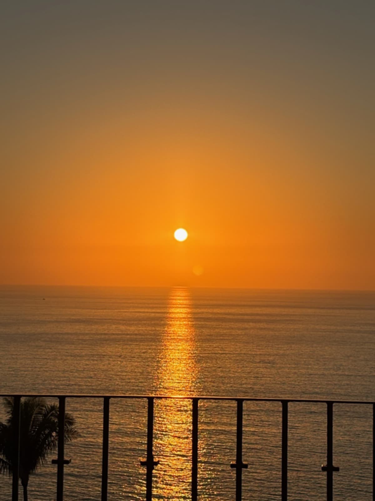Sunrise over Puerto Vallarta ocean with golden light reflecting on water