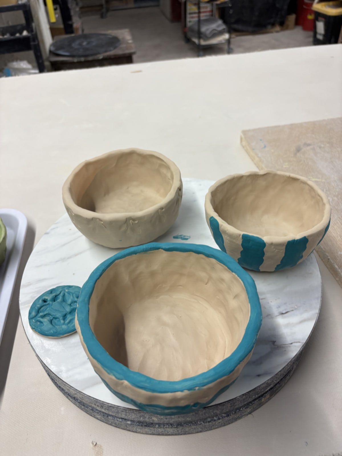 Hands working on pottery in a craft class
