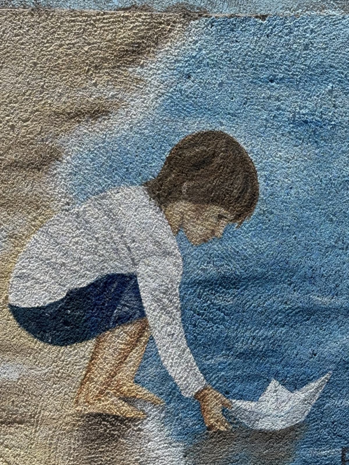 Famous painting of a child playing with a boat near water