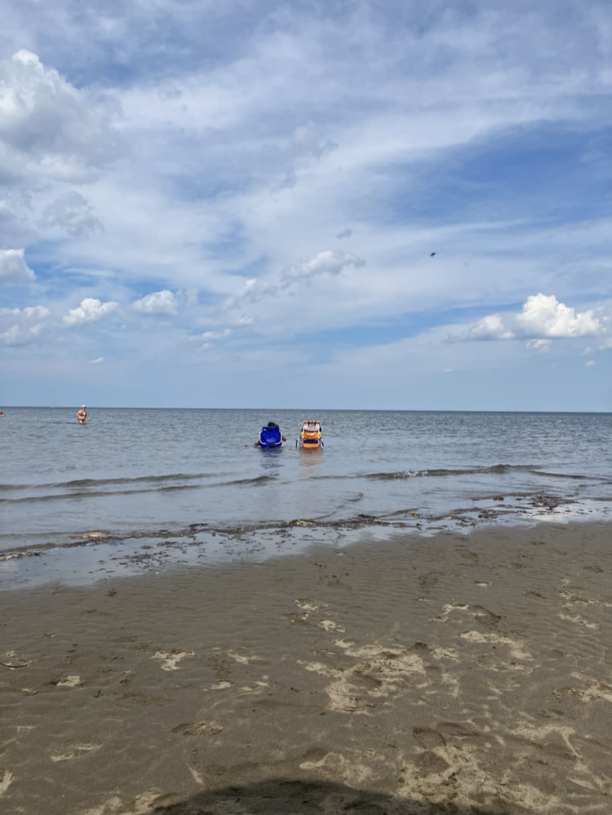 Beach chairs sitting in shallow water