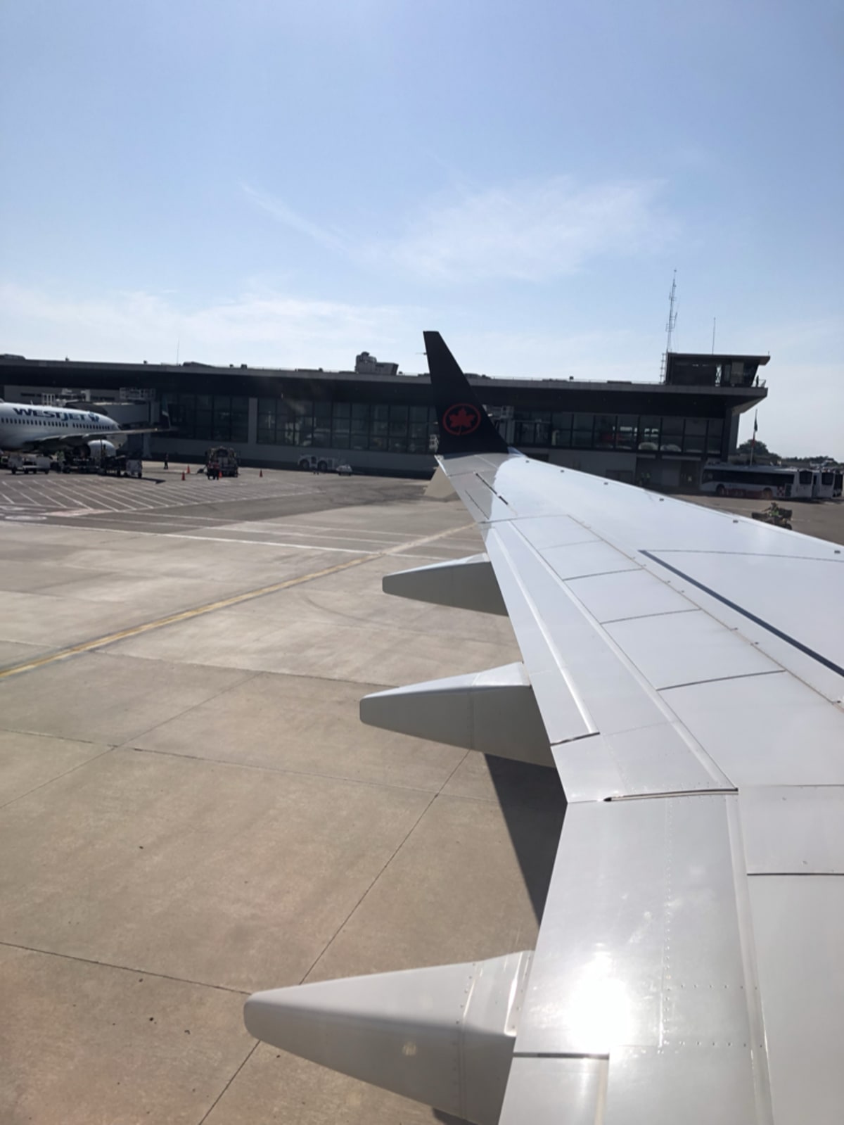 Airplane wing view from above the clouds — finding joy in the journey between departures
