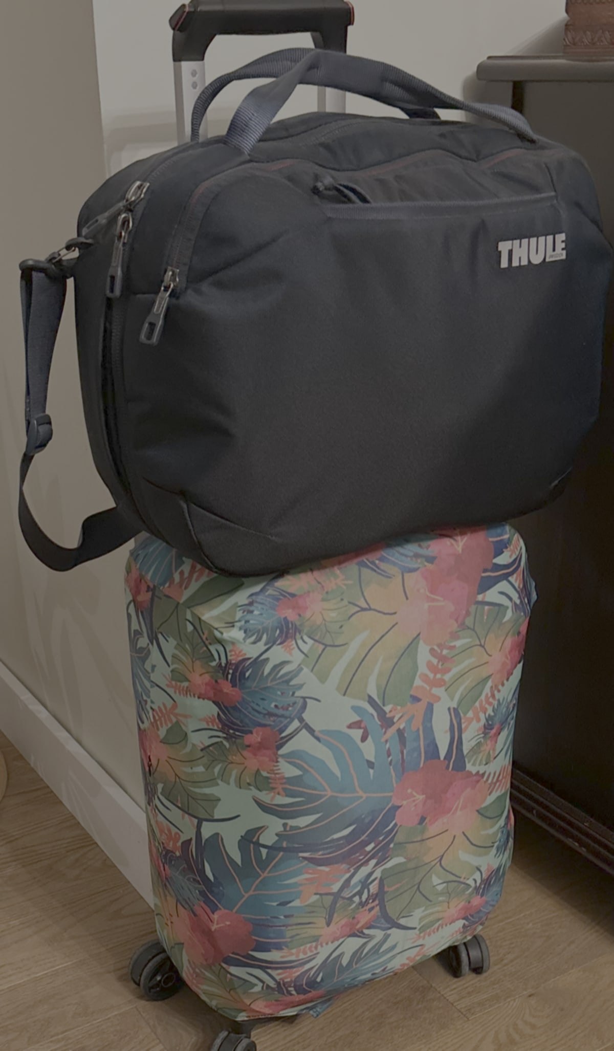 Neutrally coloured luggage packed neatly with coordinated travel outfits