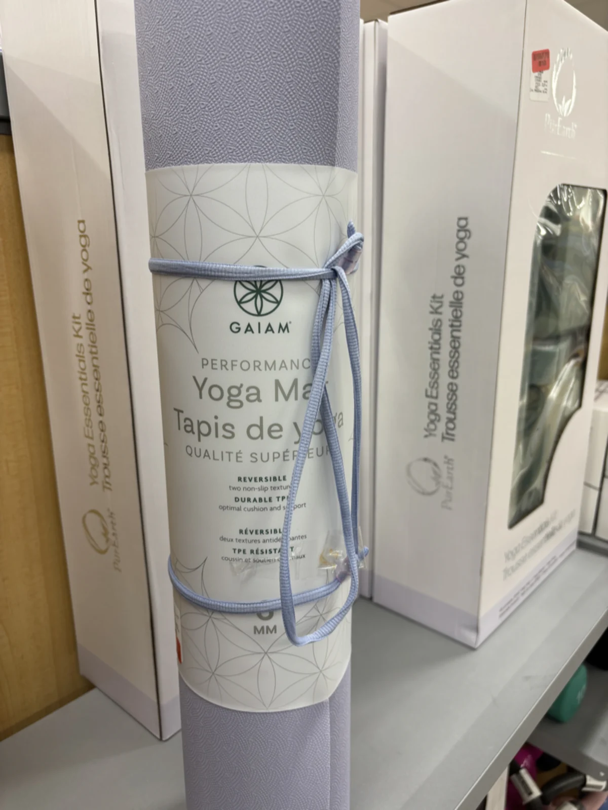 A yoga mat rolled out and ready for practice, a reminder to slow down