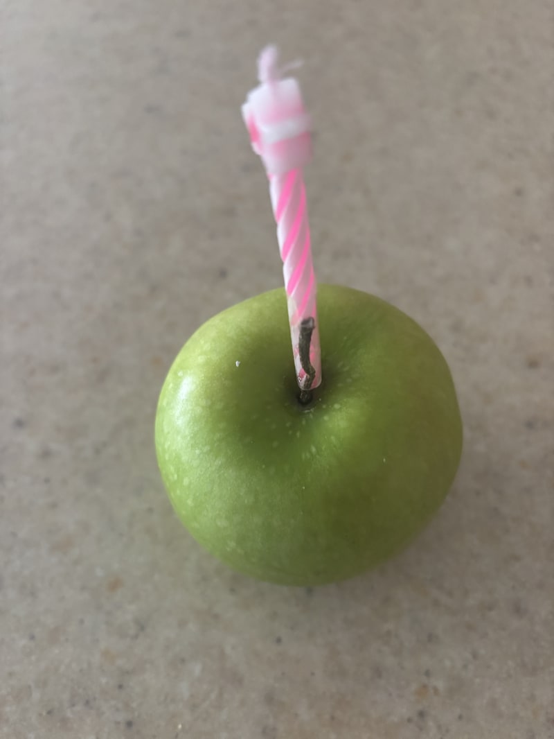 Green apple with candle for birthday celebration